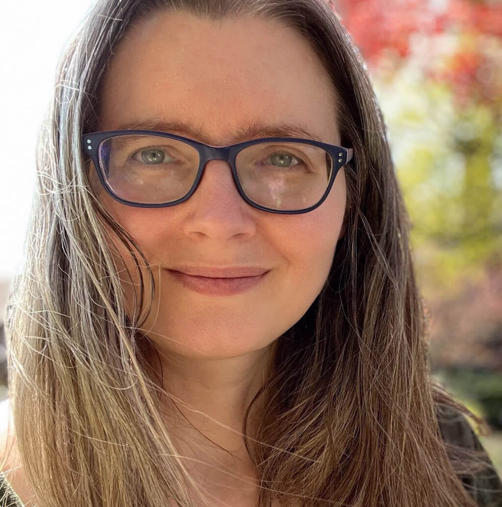 Photo of Sabrina Culyba - purple glasses with long brown hair and light complexion